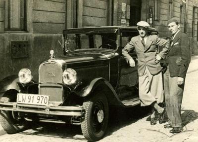 Two men near a passenger car on the street