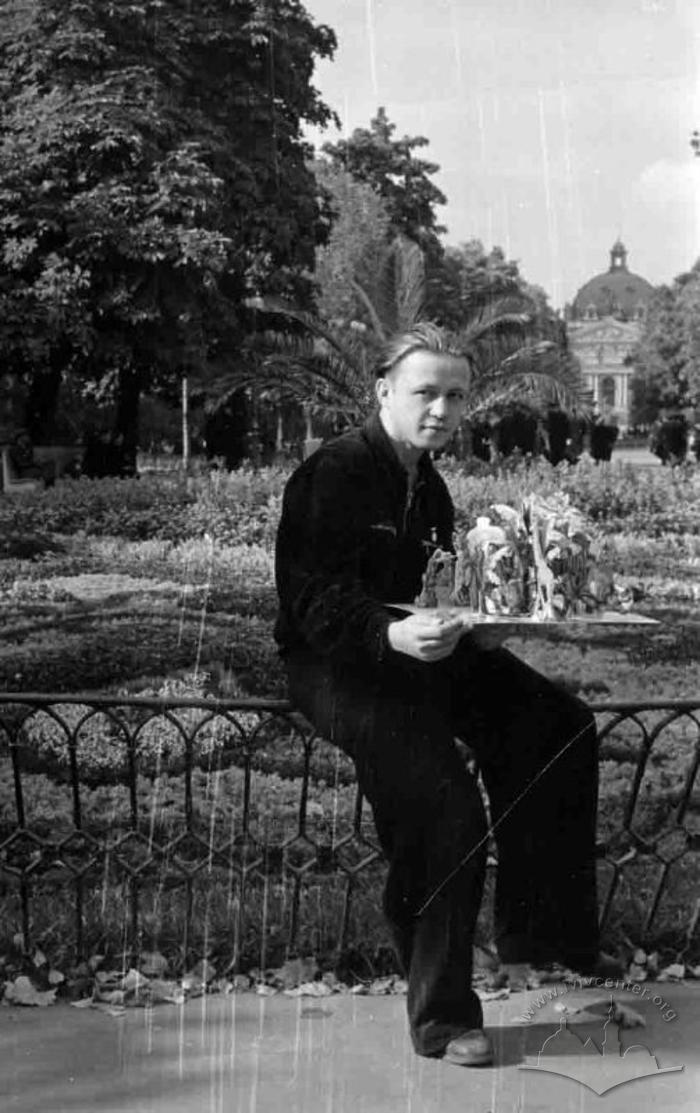 Young man near flower arrangement in the Svoboda Avenue 2