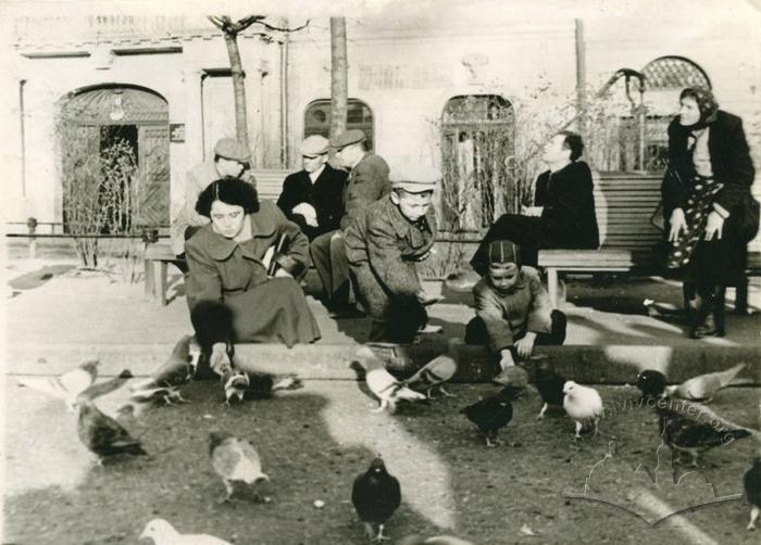 Діти годують голубів у сквері на пл. І. Підкови 2
