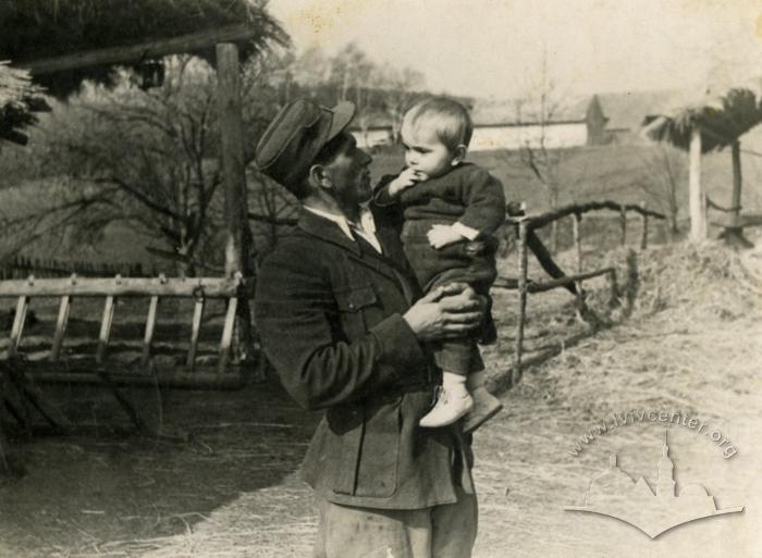 Man with a child on his arms 2