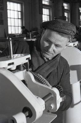 An employee of the machine-building factory Kitaiev assembles gear rolling press