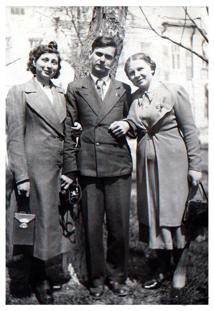 Man and two women on the street 2
