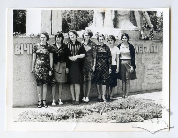 Group of women standing by a memorial 2