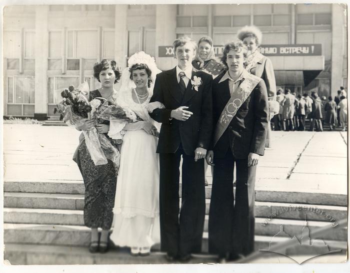 Newlyweds with best man and bridesmaid on the street 2