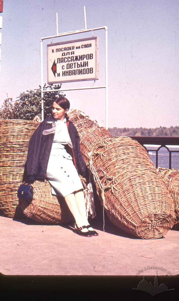 Young woman by a heap of baskets 2