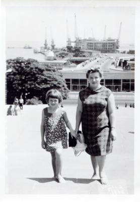 Woman with a girl on a street in summer