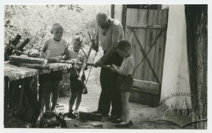 Grandpa at his desk in the garden with Valera, Vova and Yura 2
