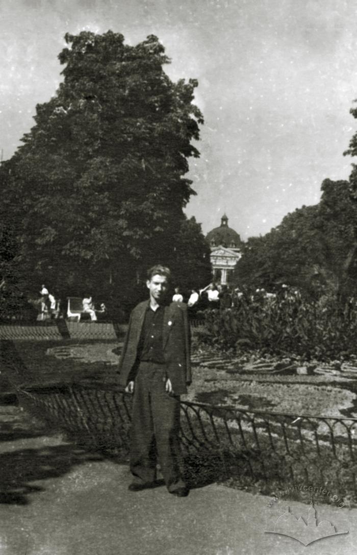 Young man near a flowerbed on Svobody avenue 2